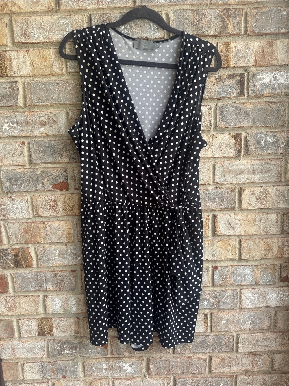 Polka Dot Sleeveless Wrap Romper in Black